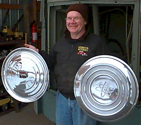 Don Mayton holding Futurliner hubcaps.
